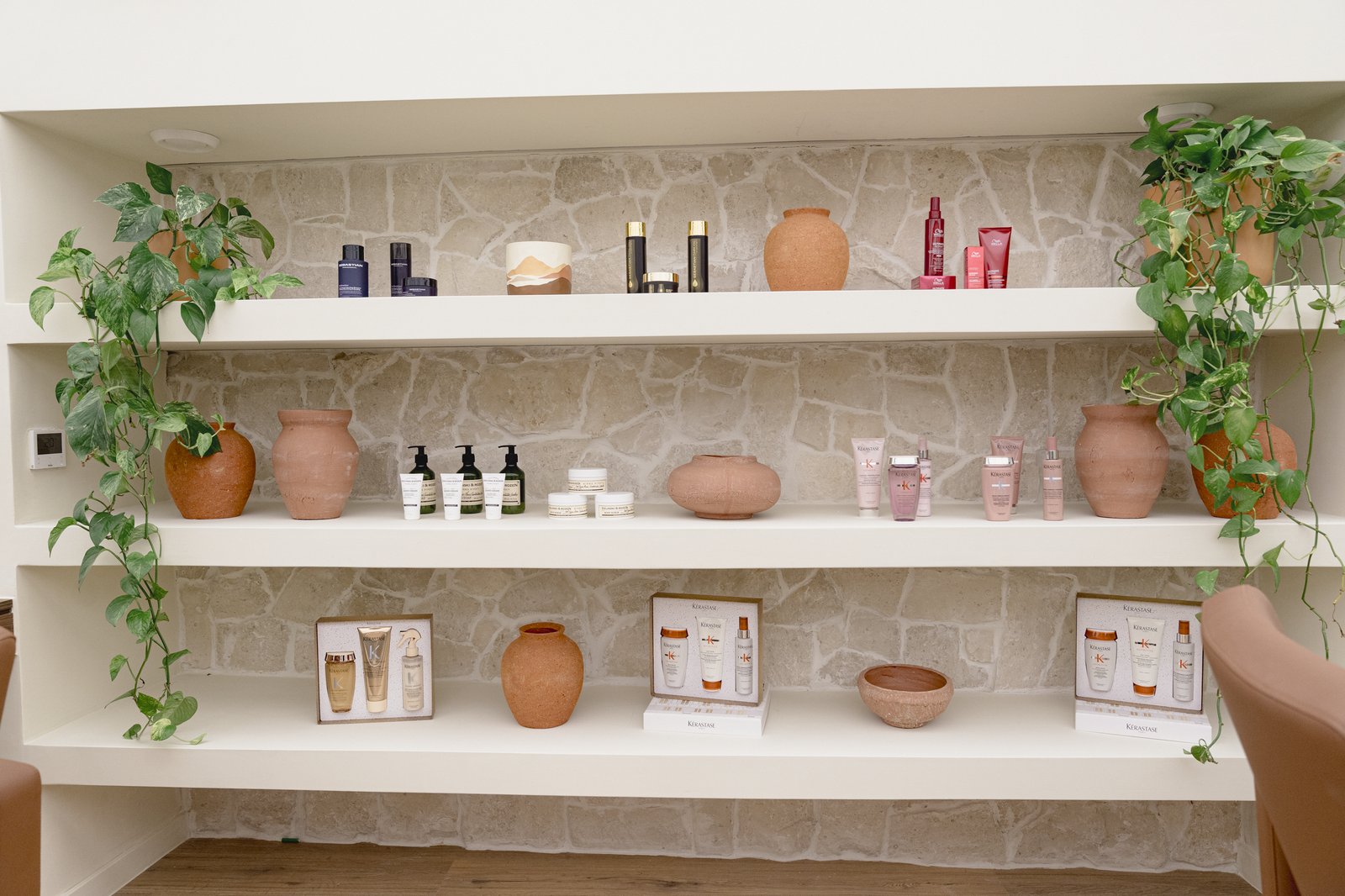 Stone wall with product shelves at the Art.Z Wellness Club